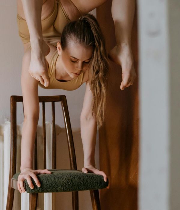Woman performing a core-strengthening yoga pose with focus and grace.